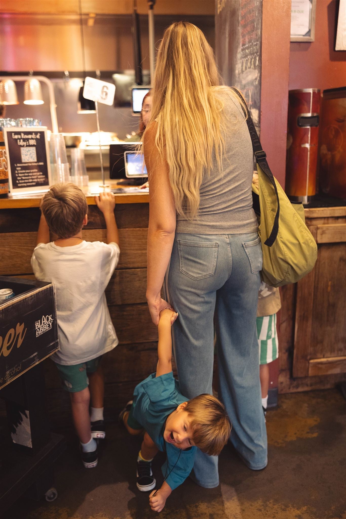 Toddler starting to have a meltdown while mom is in line